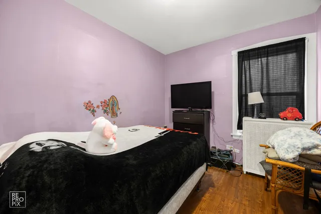 a bedroom with a bed and flat screen tv