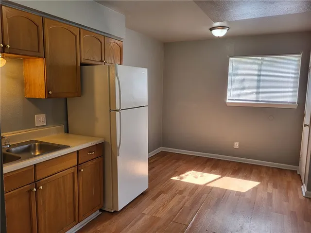 a kitchen with a refrigerator and a sink