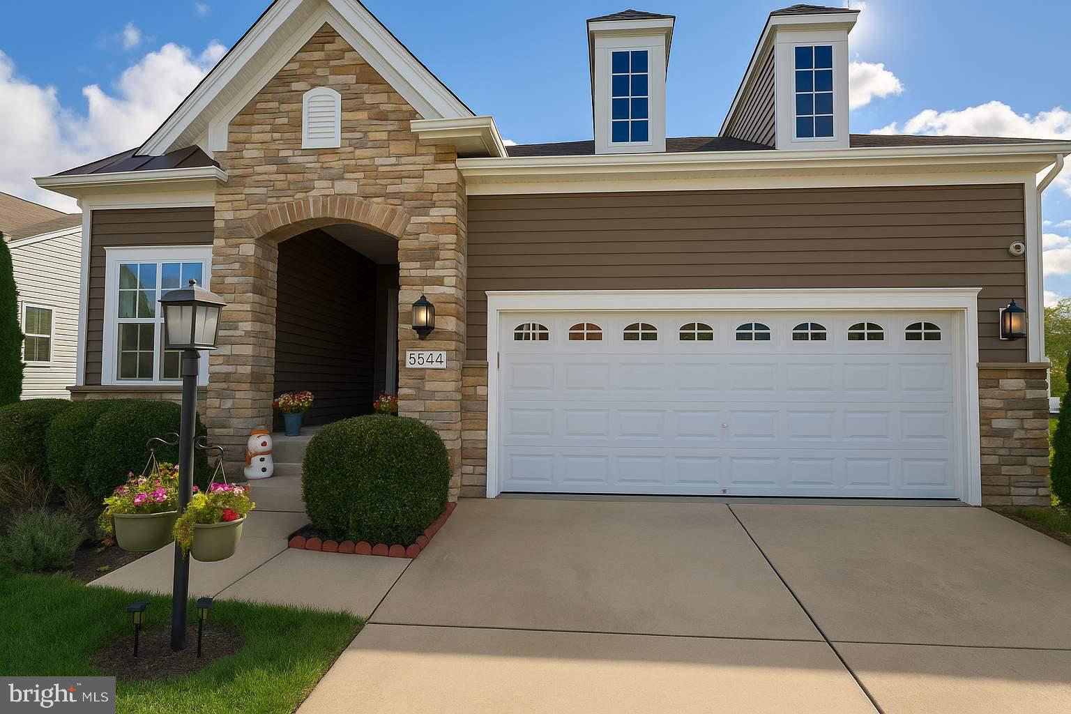 5544 Old Colony Court White Plains, MD 20695 - Photo 1 of 24 a front view of a house with a garden