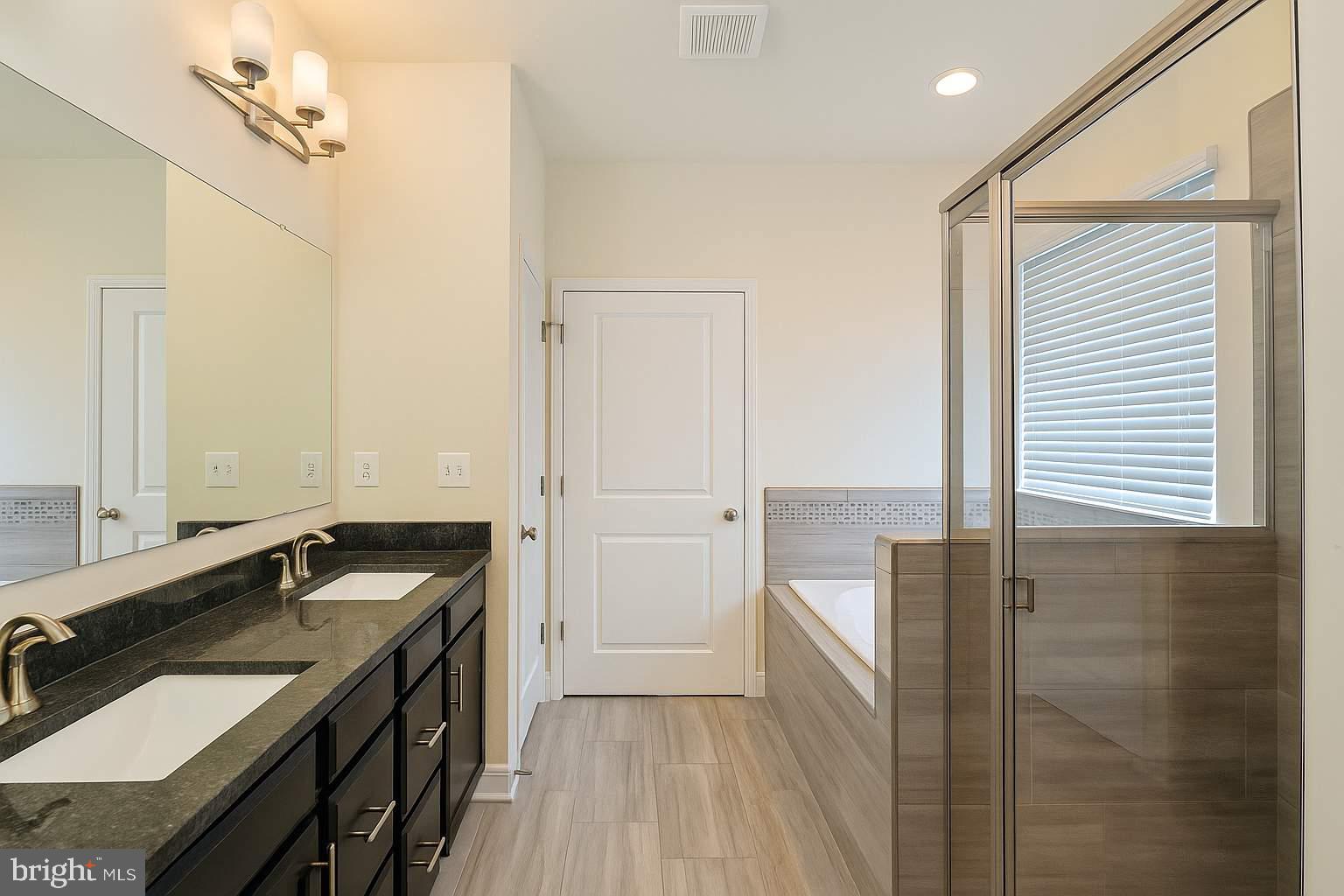 5544 Old Colony Court White Plains, MD 20695 - Photo 14 of 24 a bathroom with a sink and a mirror