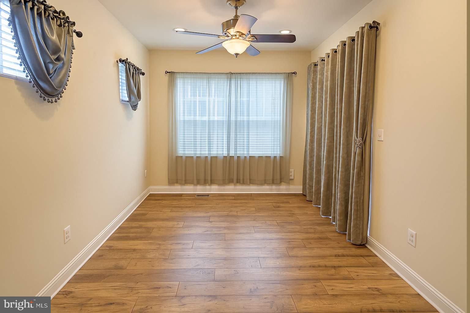 5544 Old Colony Court White Plains, MD 20695 - Photo 21 of 24 a view of an empty room with a window and wooden floor