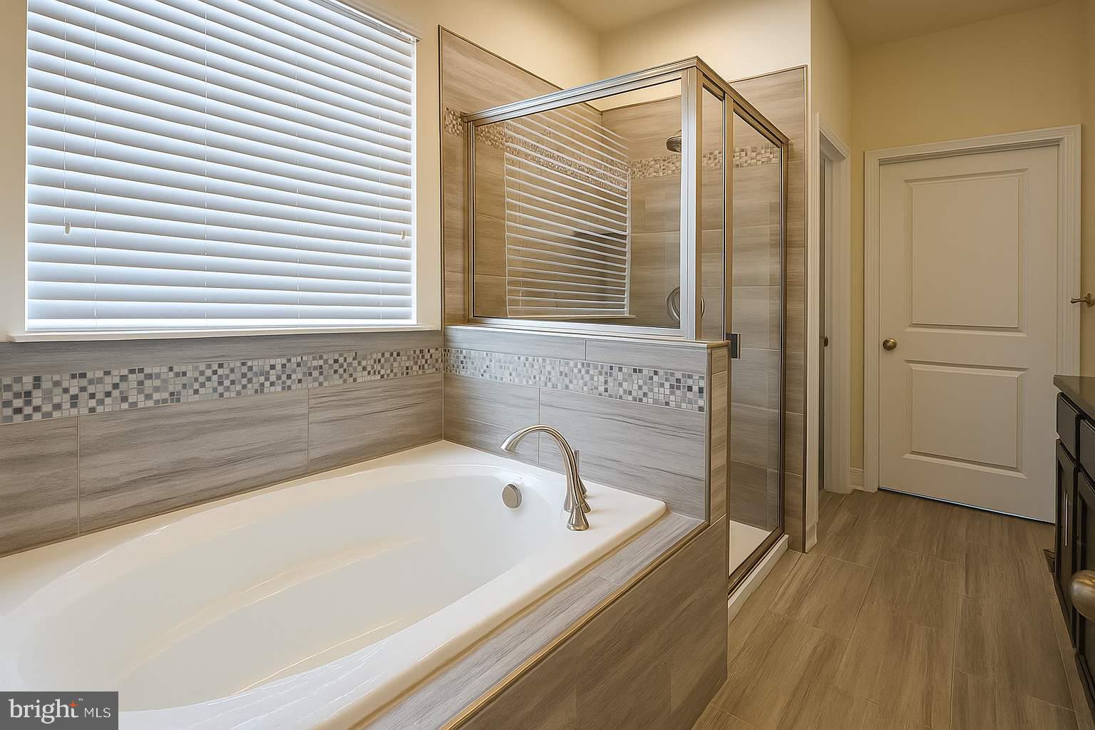 5544 Old Colony Court White Plains, MD 20695 - Photo 24 of 24 a bathroom with a bathtub and a shower