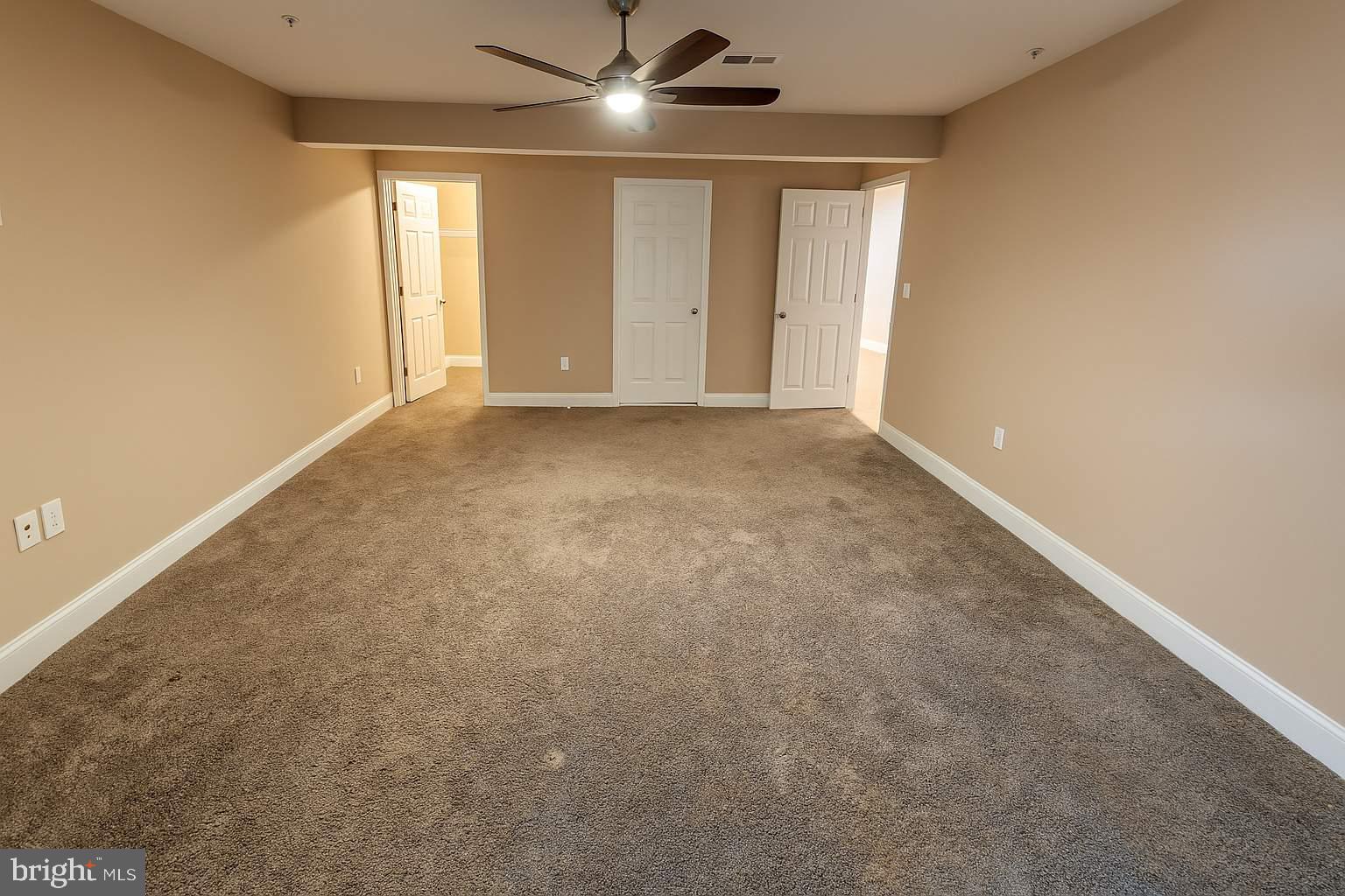 5544 Old Colony Court White Plains, MD 20695 - Photo 4 of 24 an empty room with windows and fan