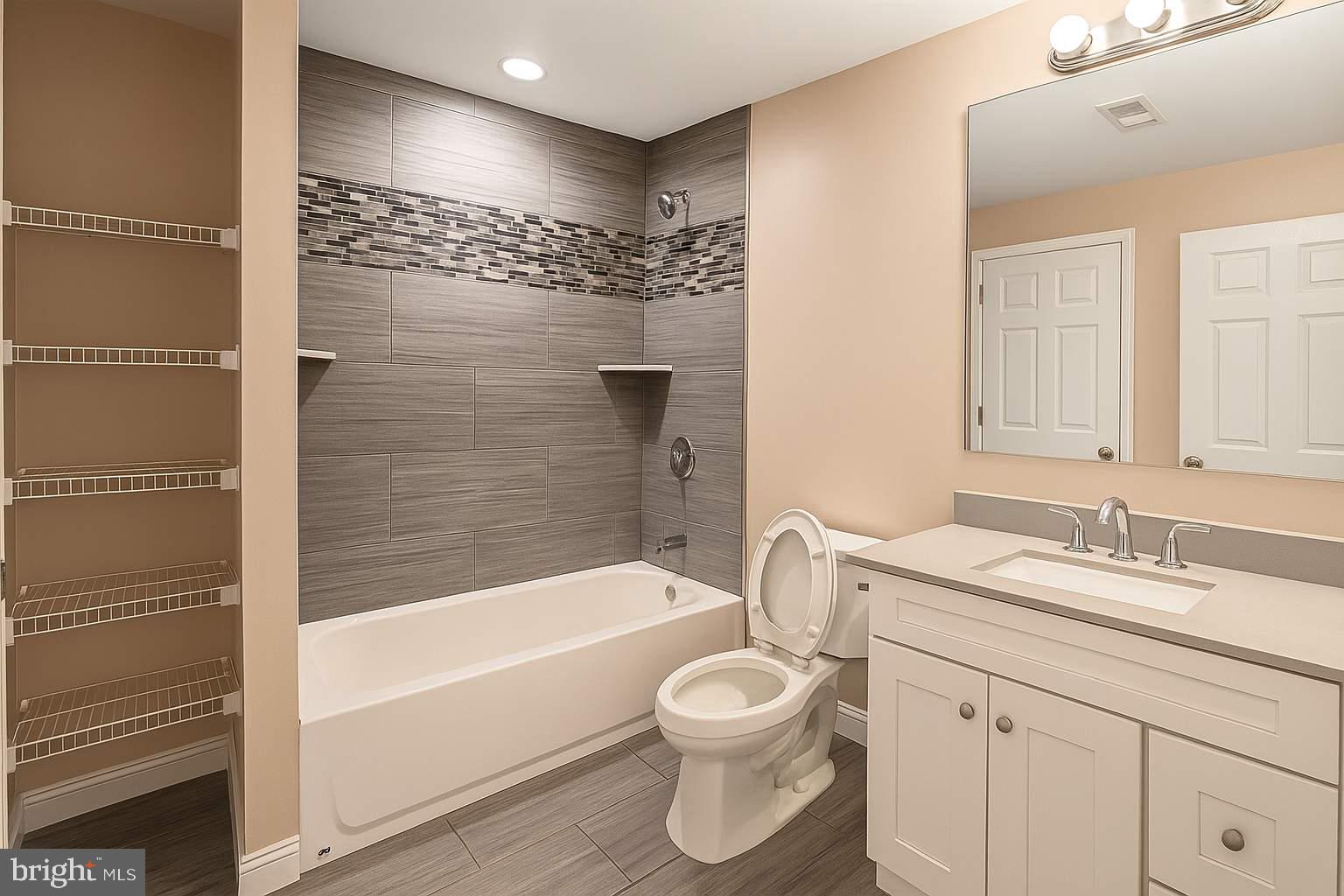 5544 Old Colony Court White Plains, MD 20695 - Photo 6 of 24 a bathroom with a bathtub shower sink vanity and toilet
