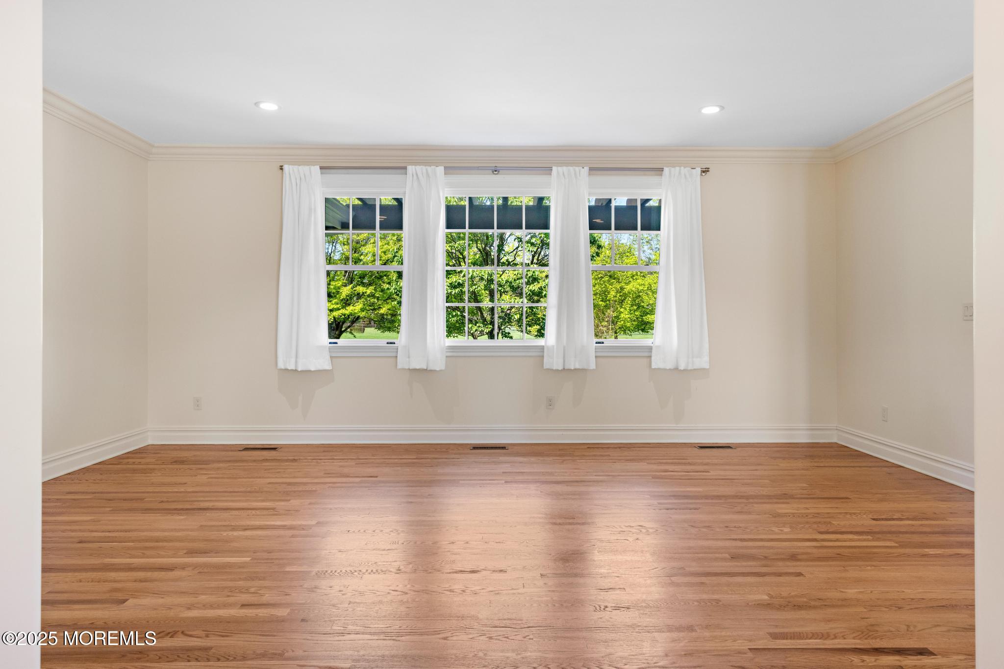 13 Driftwood Lane Colts Neck, NJ 07722 - Photo 23 of 88 a view of an empty room with wooden floor and a window