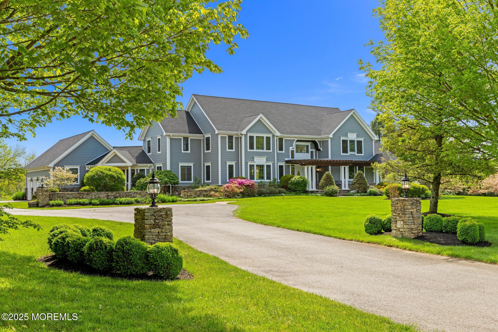 13 Driftwood Lane Colts Neck, NJ 07722 - Photo 3 of 88 a front view of a house with a yard and porch