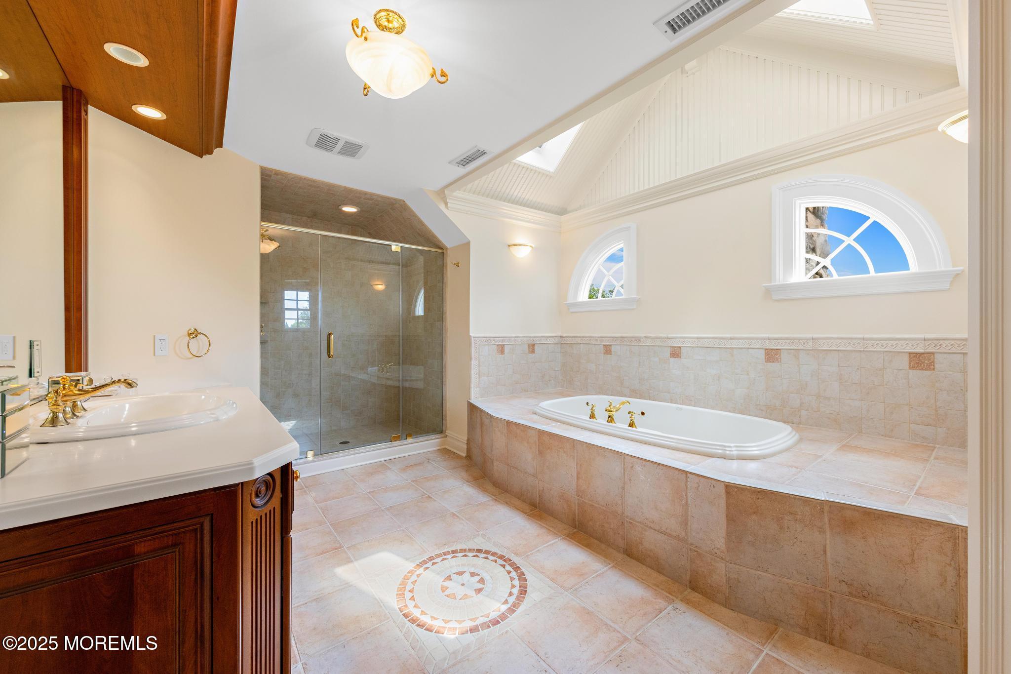 13 Driftwood Lane Colts Neck, NJ 07722 - Photo 34 of 88 a bathroom with a sink a mirror and a bathtub