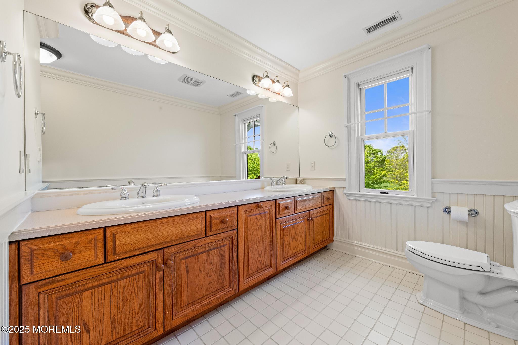 13 Driftwood Lane Colts Neck, NJ 07722 - Photo 40 of 88 a bathroom with a granite countertop double vanity sink a mirror and a bathtub