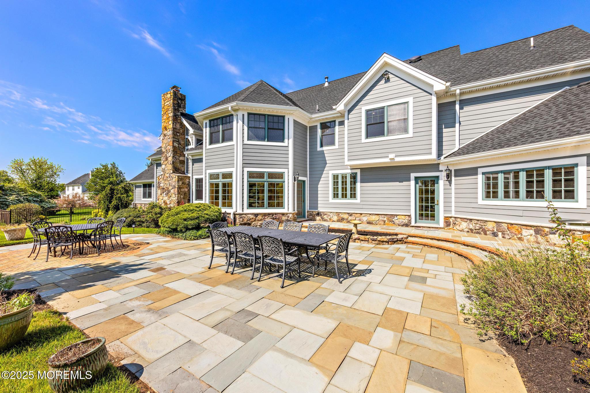 13 Driftwood Lane Colts Neck, NJ 07722 - Photo 49 of 88 a swimming pool with outdoor seating and yard