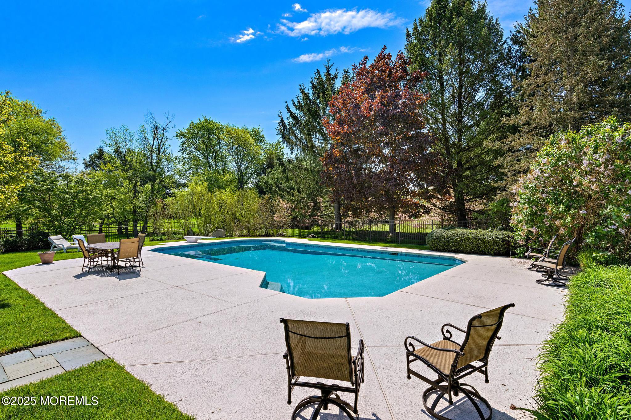 13 Driftwood Lane Colts Neck, NJ 07722 - Photo 54 of 88 a view of a swimming pool with chairs