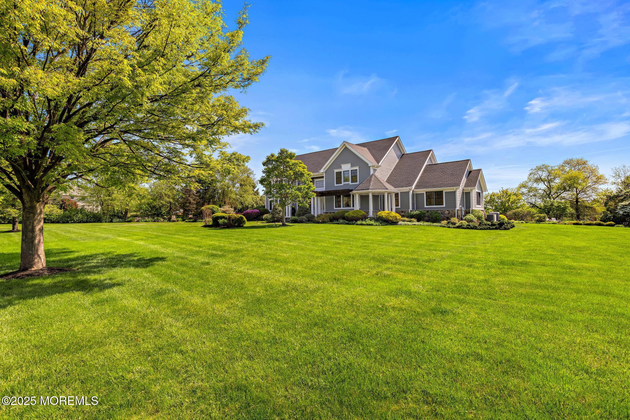 13 Driftwood Lane Colts Neck, NJ 07722 - Photo 56 of 88 a front view of a house with garden