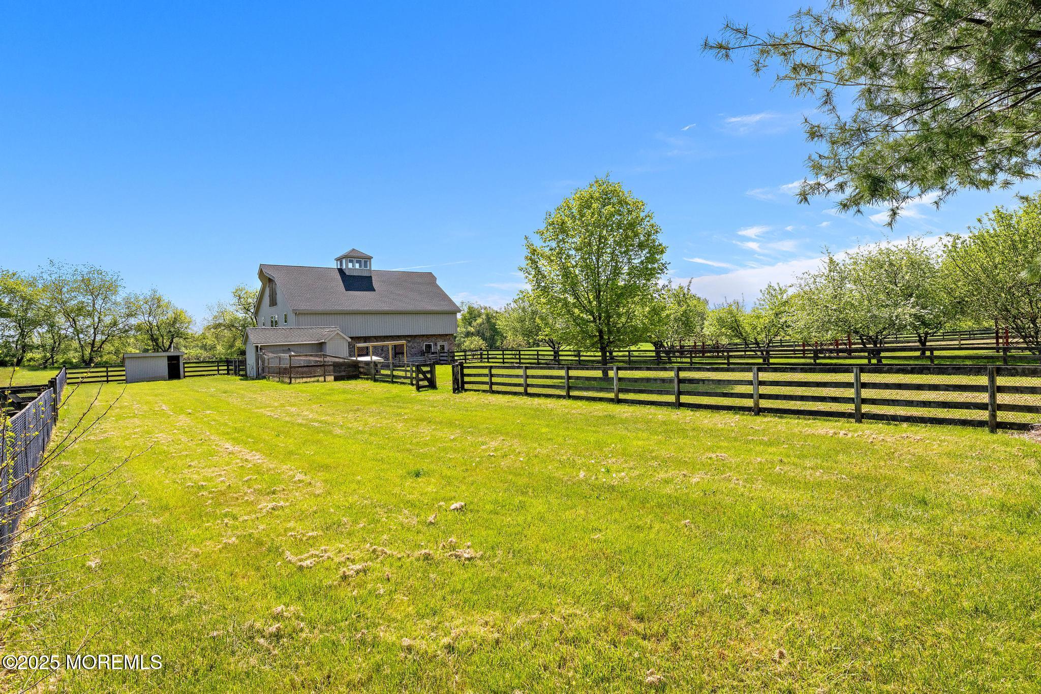 13 Driftwood Lane Colts Neck, NJ 07722 - Photo 76 of 88 a view of a swimming pool with an outdoor seating and a garden