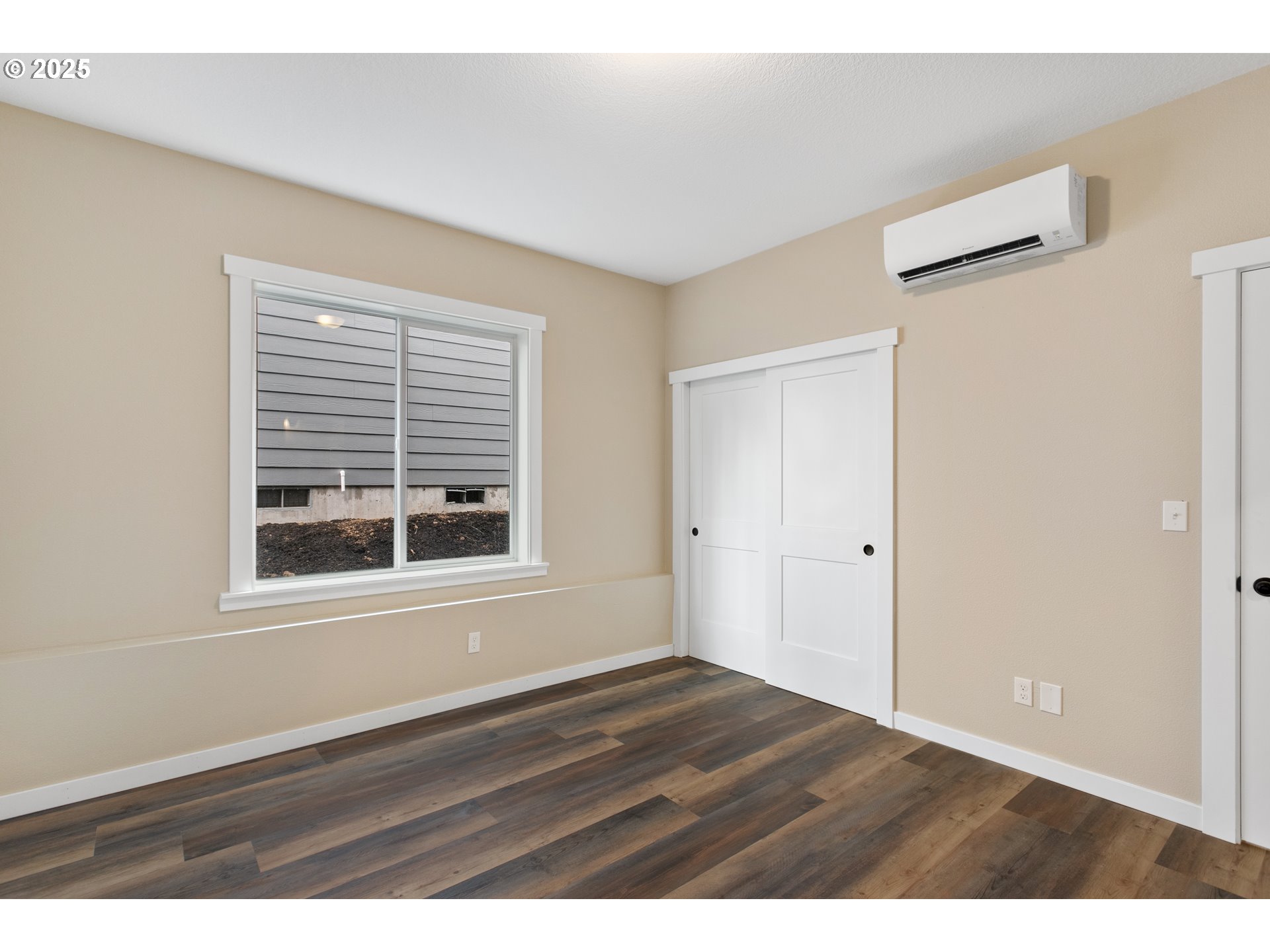 144 East H Street Vernonia, OR 97064 - Photo 12 of 35 a view of an empty room with wooden floor and a window