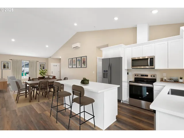 a kitchen with white cabinets a sink and dishwasher