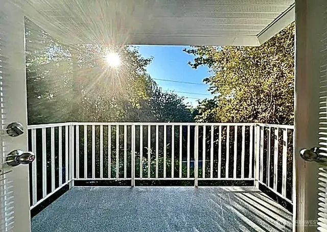 a living room with furniture and a dining table