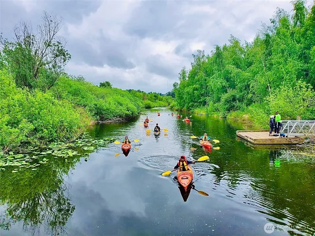 a view of a living room with furniture and a large window