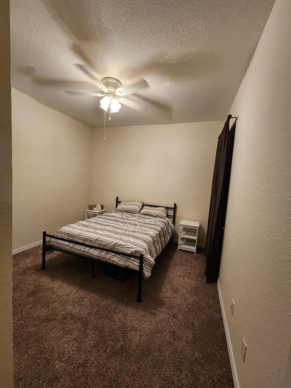 9027 Stone Harbour Loop Bradenton, FL 34212 - Photo 15 of 20 a bedroom with a bed and a chandelier