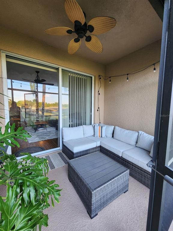 9027 Stone Harbour Loop Bradenton, FL 34212 - Photo 19 of 20 a living room with furniture and a floor to ceiling window