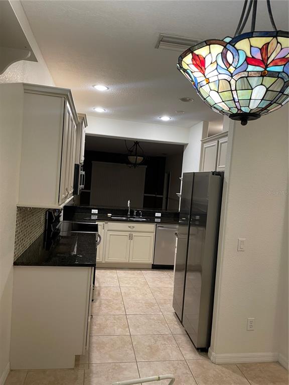 9027 Stone Harbour Loop Bradenton, FL 34212 - Photo 4 of 20 a kitchen with stainless steel appliances granite countertop a refrigerator and a sink