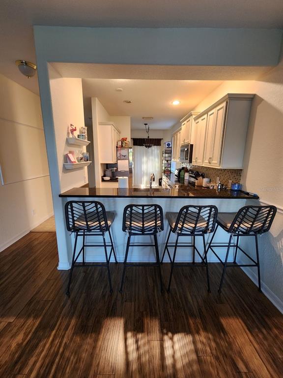 9027 Stone Harbour Loop Bradenton, FL 34212 - Photo 5 of 20 a view of a dining room with furniture and wooden floor