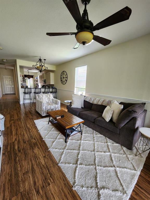 9027 Stone Harbour Loop Bradenton, FL 34212 - Photo 6 of 20 a living room with lots of furniture and wooden floor
