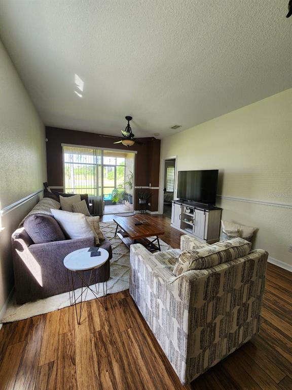 9027 Stone Harbour Loop Bradenton, FL 34212 - Photo 7 of 20 a living room with furniture and a flat screen tv