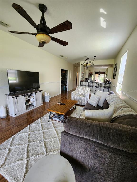 9027 Stone Harbour Loop Bradenton, FL 34212 - Photo 8 of 20 a living room with furniture and a flat screen tv