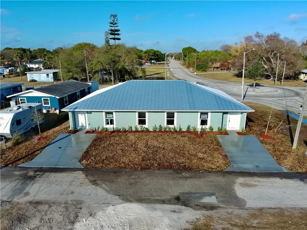 a aerial view of a house next to a yard