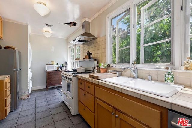 a kitchen with a sink stove and refrigerator