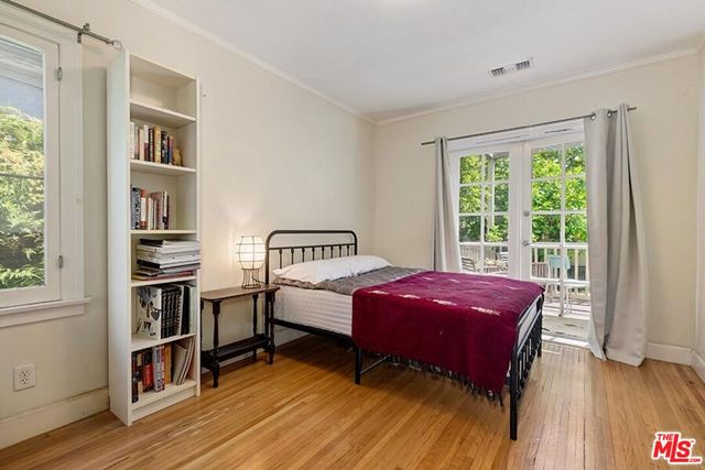 a bedroom with a bed and a bookshelf