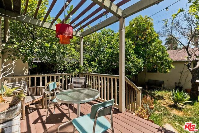 a view of a chairs and table in patio