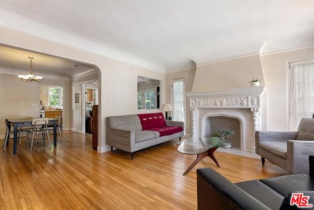 a living room with furniture a fireplace and a table