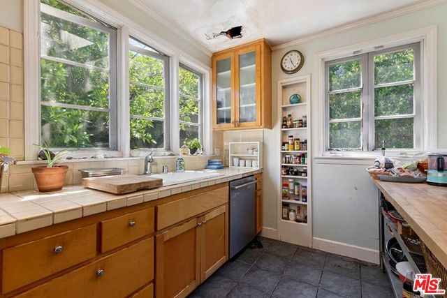 a kitchen with a window a sink and a counter