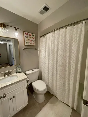 a bathroom with a toilet a sink and a mirror