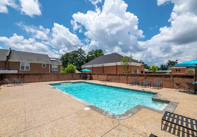 a view of a backyard with sitting area