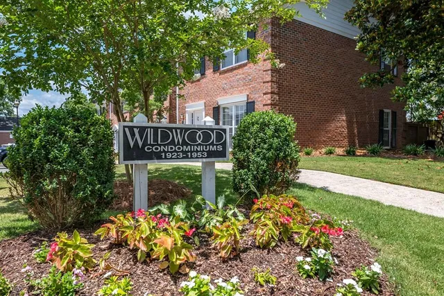 a sign that is sitting in front of flowers