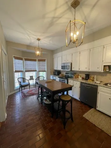 a open kitchen with dining table and chairs