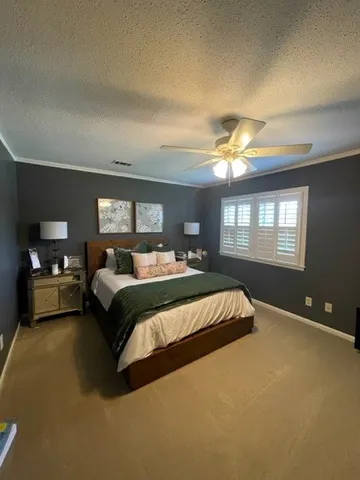 a spacious bedroom with a bed and window