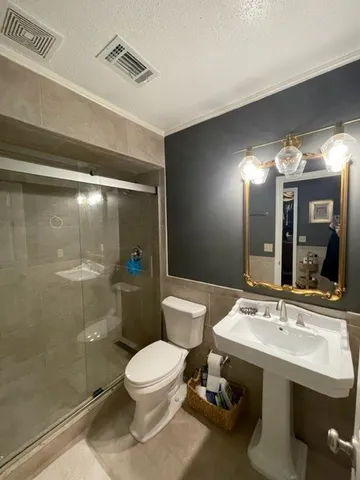 a bathroom with a sink toilet and shower