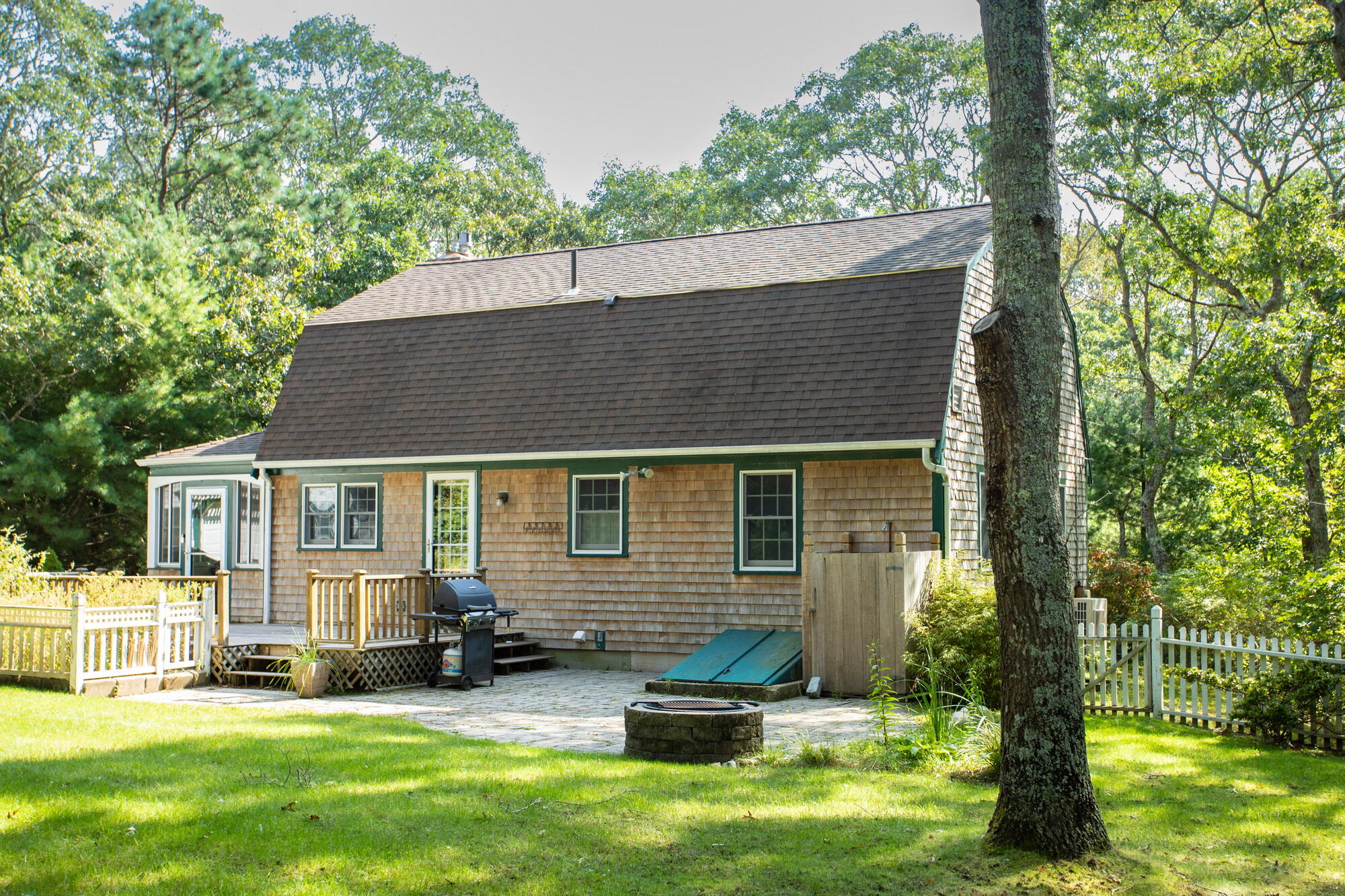 150 Old Mill Road Marstons Mills, MA 02648 - Photo 25 of 29 a backyard of a house with yard table and chairs