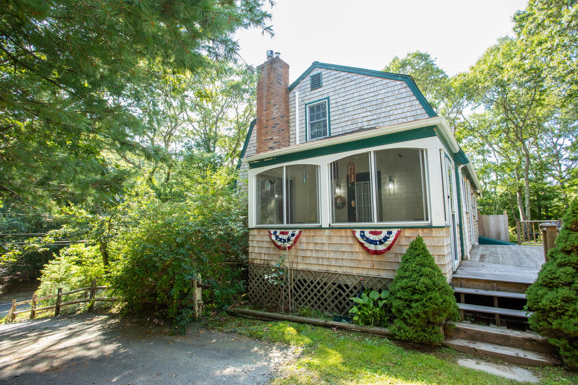 150 Old Mill Road Marstons Mills, MA 02648 - Photo 3 of 29 a front view of a house with a garden