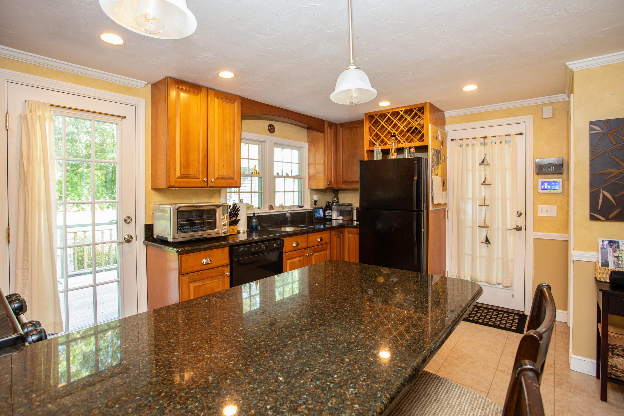 150 Old Mill Road Marstons Mills, MA 02648 - Photo 6 of 29 a kitchen with stainless steel appliances granite countertop a refrigerator a stove top oven and a refrigerator