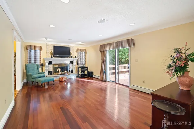 a living room with furniture a fireplace and a flat screen tv