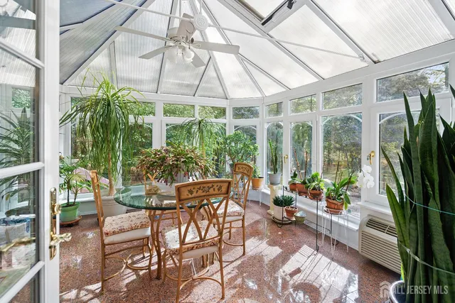 a view of a patio with furniture and garden