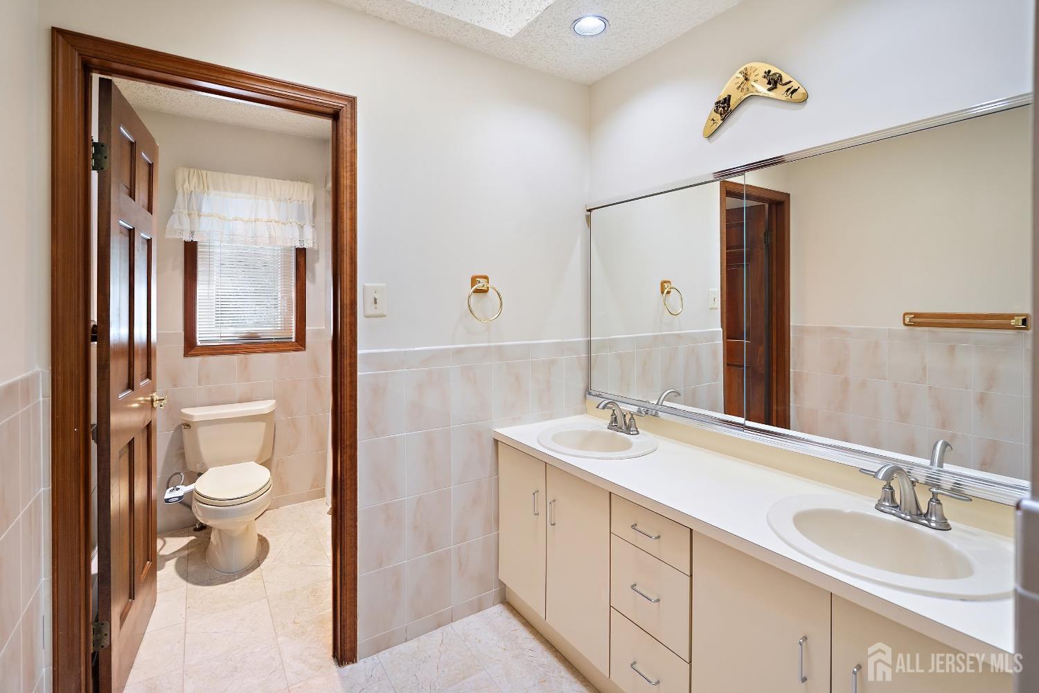 3 Anthony Avenue Edison, NJ 08820 - Photo 22 of 41 a bathroom with a toilet sink and mirror