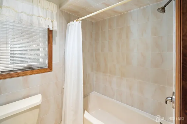 a bathroom with a bathtub and shower