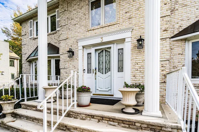 front view of a house with potted plants