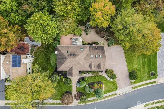 an aerial view of a house with garden space and street view