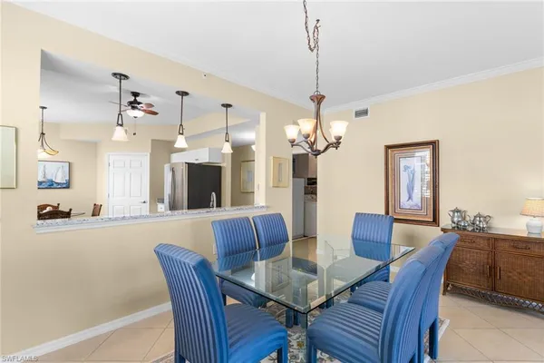 a view of a dining room with furniture wooden floor and chandelier