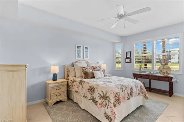 a bedroom with double bed and large window